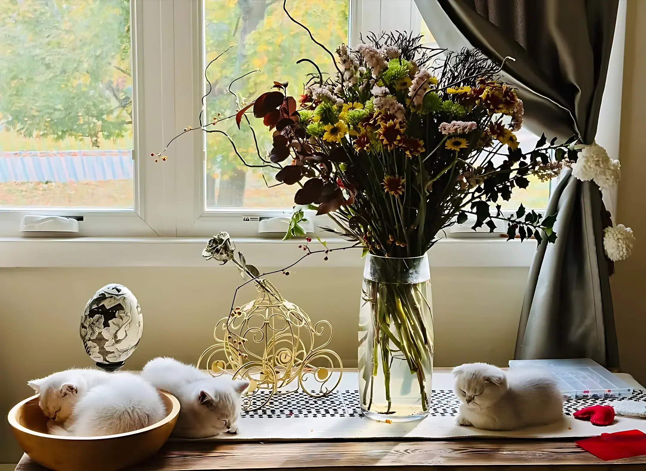 Autumn chrysanthemums in a glass vase on a sunny windowsill