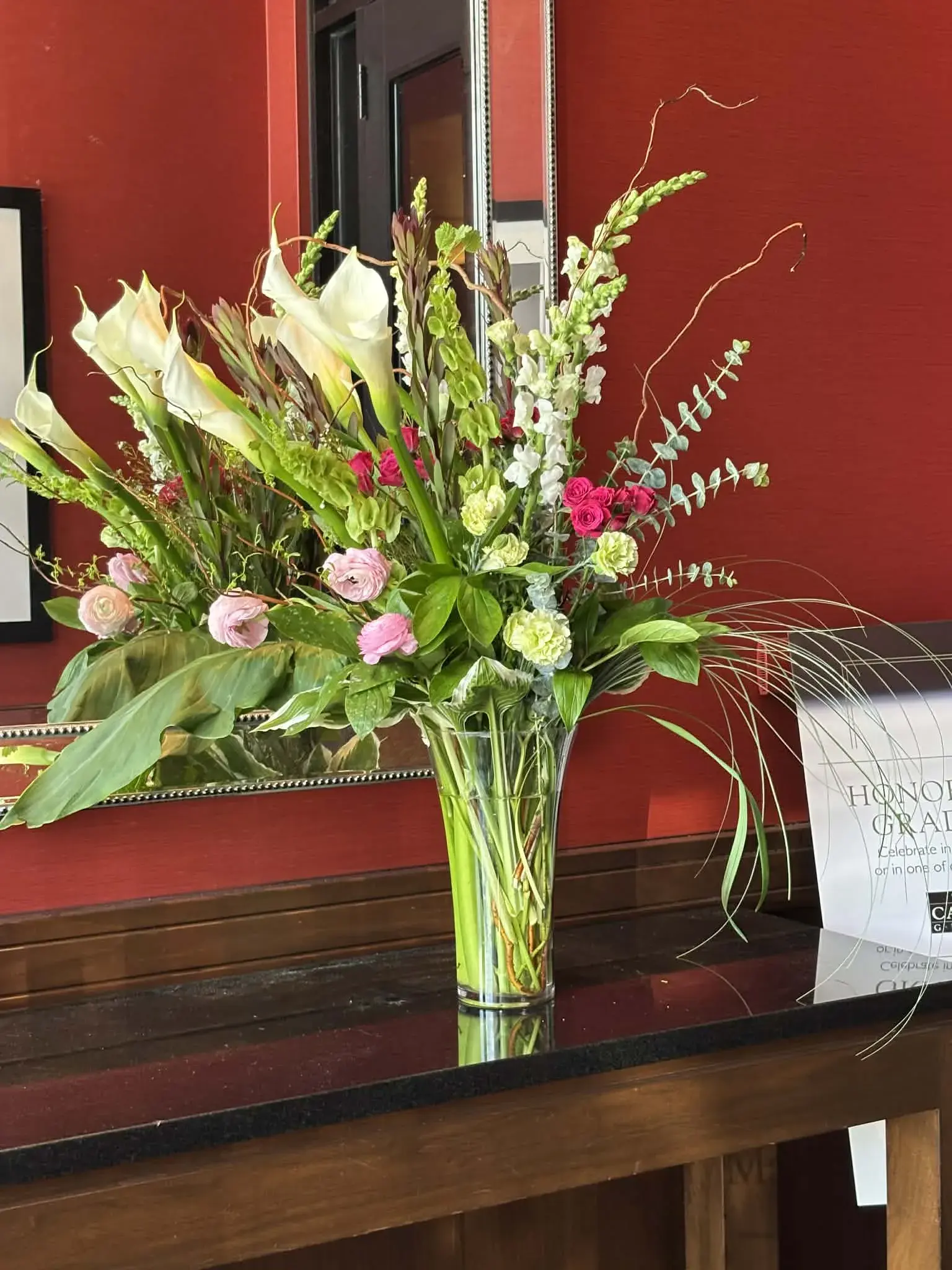 Graceful tall arrangement with curly willow and seasonal blooms
